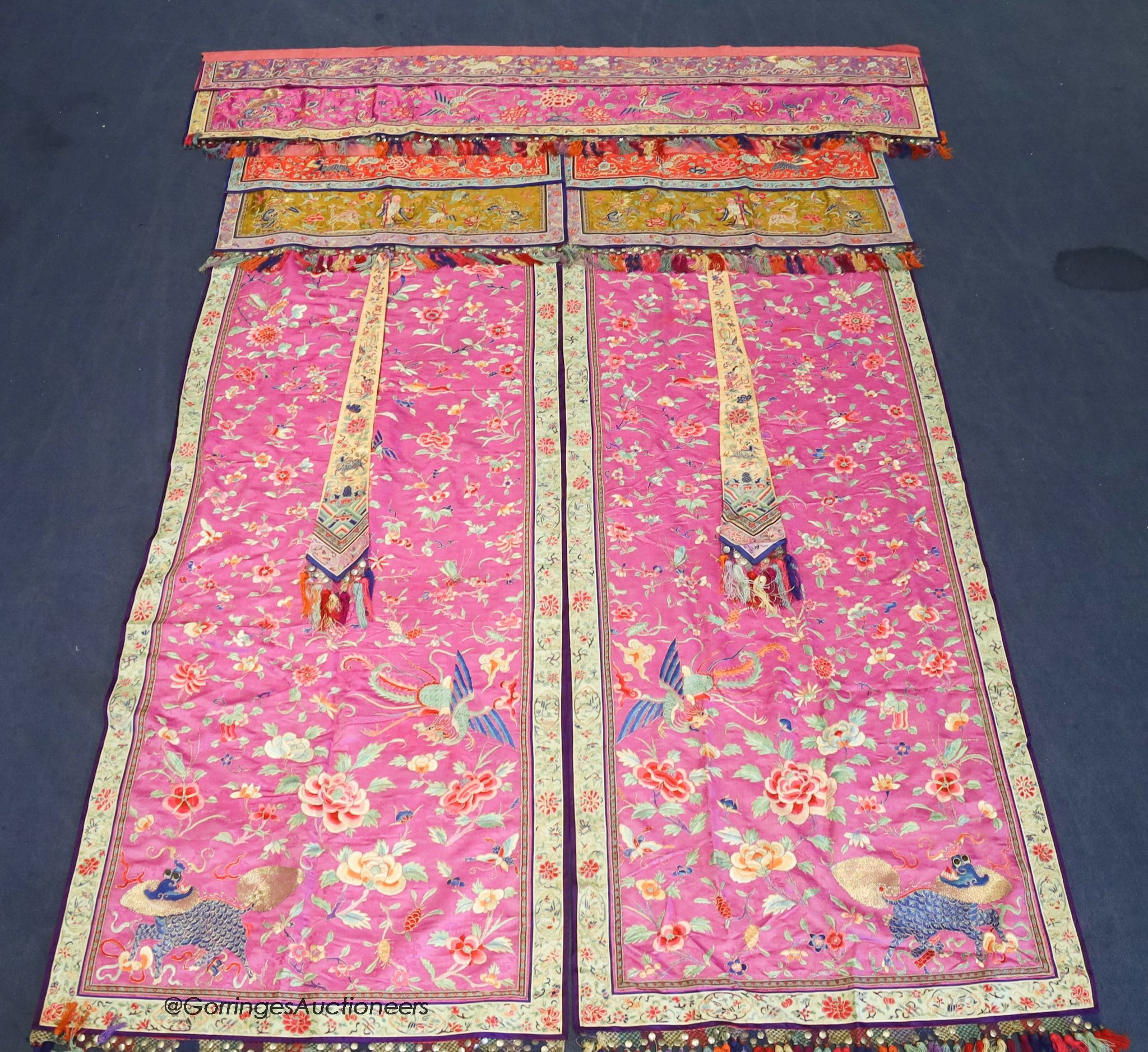 A pair of 20th century Chinese silk embroidered ceremonial panels, possibly for a wedding, 228cm not including fringing, each panel width 80cm, with a matching pelmet, width 198cm